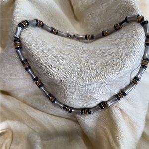 Stylish Silver and Black Necklace with Gold Accents